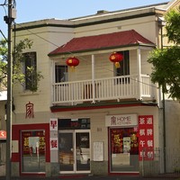 Two story building with signage showing Chinese characters 