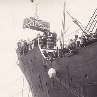 Image: casket being unloaded by crane from a ship