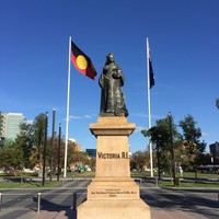 Image: large statue of woman with two flags behind