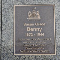 Bronze plaque set in pavement inscribed with name and City of Adelaide logo
