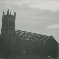 Image: a church with roof tiles removed. 