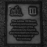 Image: bronze plaque with logos and text