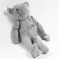 Image: worn teddy bear with stuffing showing