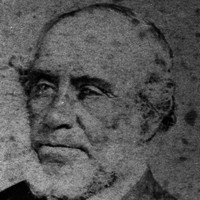 Image: A faded head-and-shoulders photographic portrait of an elderly man with thinning hair and a chin-beard