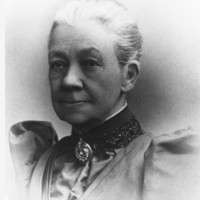 Image: black and white photo of head and shoulders of older woman