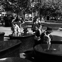 Image: children playing with the water in a fountain