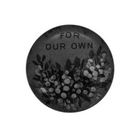 Image: A small circular badge with painted wattle flowers with text above them which says for our own