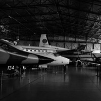 Image: group of planes in large hanger style building