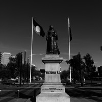 Image: large statue of woman with two flags behind