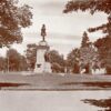 Image: Bronze statue of a man atop a granite pillar