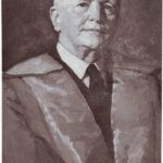 Image: A painted portrait of a middle-aged Caucasian man wearing a mid-twentieth century suit and academic regalia