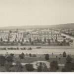 Image: View of large public square from above, featuring many horses and carriages