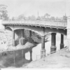 image: iron bridge across a river