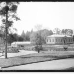 Image: grass and pond with Greek Revival style building in the background