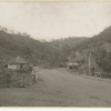 Image: Children standing on road with hills and toll house