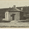 Image: Small hexagonal toll building with plaque