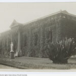 Image: Greek Revival style building covered in ivy