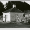 Image: Toll house and gate next to modern road