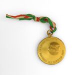 Image: bronze medal with striped ribbon