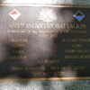 Image: Metal plaque mounted on a granite base.