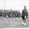 Image: Photograph of uniformed soldiers on parade in regimental Scottish tartan kilts