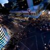 Image: The multimedia screen emits a rainbow of colors over nighttime pedestrians