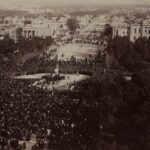 Image: crowds of people around sculpture in public square