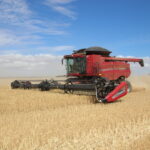 Image: A harvester in the process of harvesting a crop