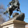 Image: The statue of a horse and rider mounting the crest of a hill