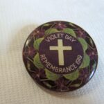 Image: purple badge with cross and violet images