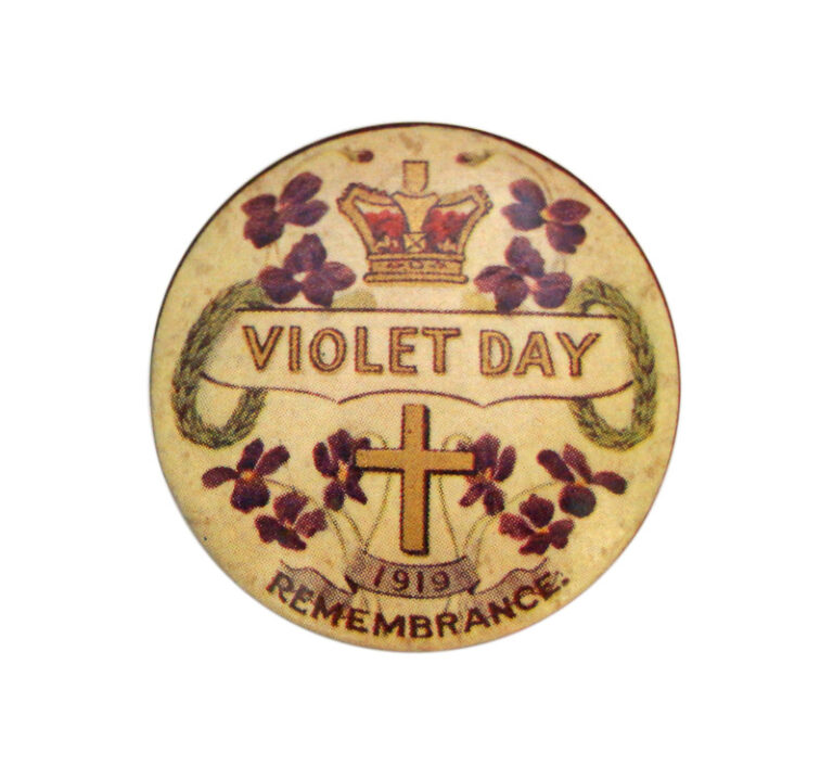Image: small circular badge with violets, cross and crown pictures