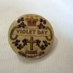 Image: badge showing picture of crown and violets