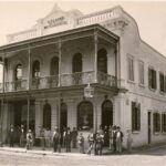 Image: men standing in front of building