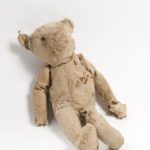 Image: worn teddy bear with stuffing showing