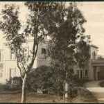 Image: Black and white photograph showing driveway and entrance porch at front of large two-storey building