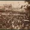 Image: a huge group of people in 1880s dress and hats surround a stage where a foundation stone is being laid.