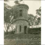 Image: Two story round stone tower on the side of a hill