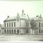 Image: a two storey stone building with a two storey bay window on one elevation, a arched loggia on another side, and ornately curved gable ends.