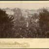 Image: crowds surrounding stone statue of standing man