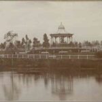 Image: A rotunda sits on a hill in a landscaped park on the bank of a river