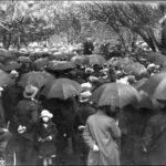 Image: Crowd of people with umbrellas gathered at anti-war public meeting