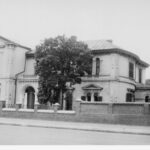 Image: Street view of a white stone mansion.