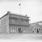 Image: A two-storey nineteenth century bluestone building on which is written the words ‘Missions to Seamen’. A one-storey wooden building immediately next door features the words ‘The Harbour Lights Guild Institute’ above its entrance