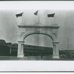 Image: Stone archway with three flags flying on top