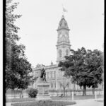 Image: view of statue in garden with building in background