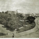 Image: View of city garden square with carts driving around