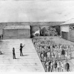 Image: A sketch of a large yard surrounded by a high stone wall, some armed men in uniforms stand looking at a large group of men standing in the yard