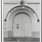 Image: a large metal arched door with a sign reading: "H.M. Gaol Adelaide"