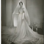 Image: A young Caucasian woman poses for a photograph in her 1940s vintage bridal gown