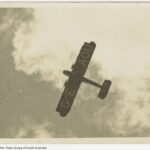 Image: underside of plane seen flying in clouds